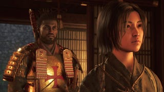 Yasuke and Naoe stand inside a dimly lit room in Assassin's Creed Shadows.