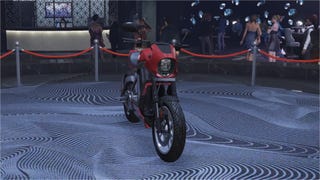 A red love fist themed Western Powersurge motorcycle is parked front-on, on the podium in the diamond casino.
