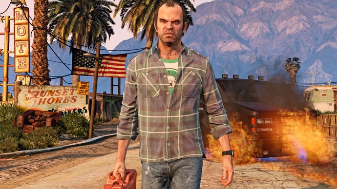 Trevor in GTA 5 carries a jerry can as a car burns behind him